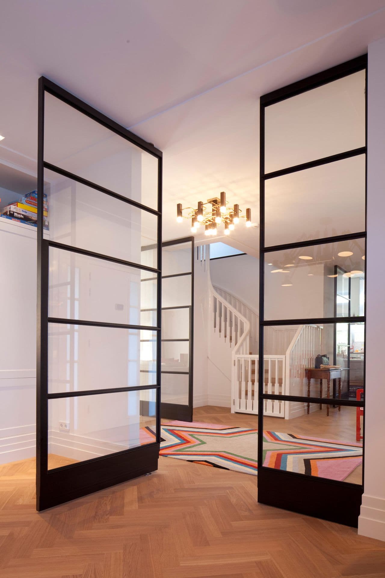 double pivot doors made of steel in a black finish with clear glazing