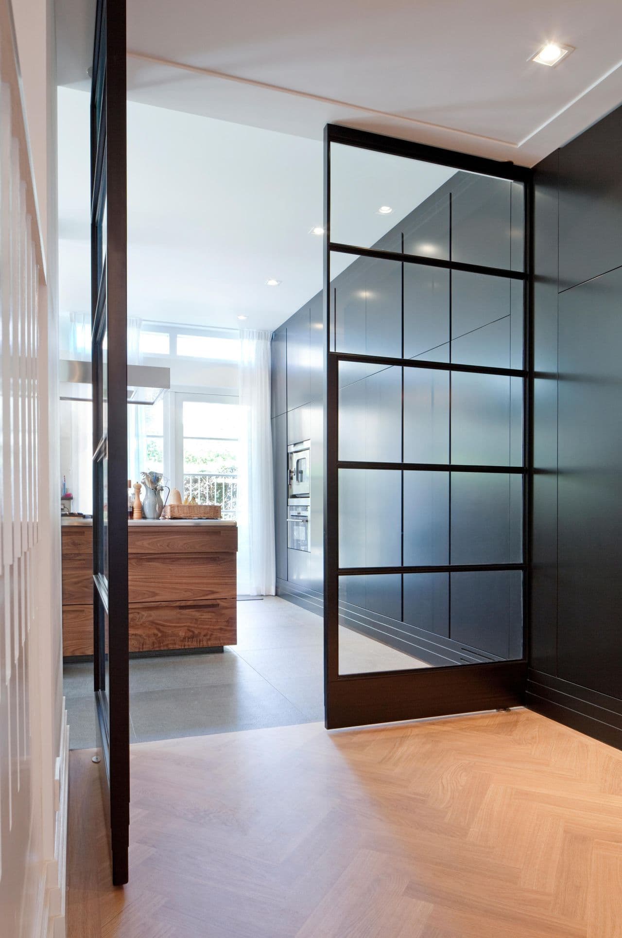 double pivoting black steel doors with wide opening angel