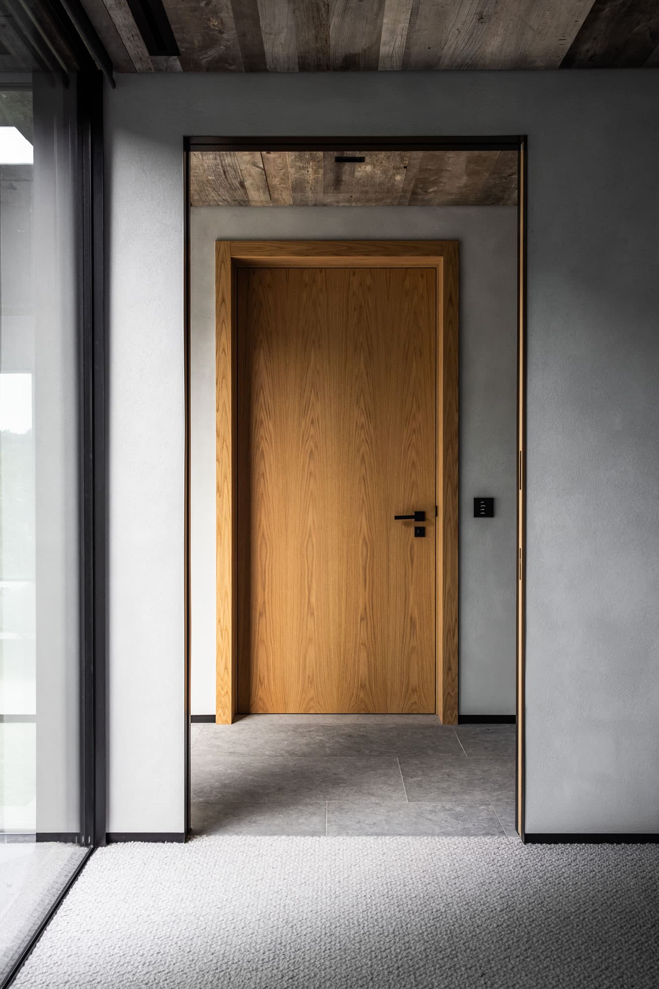 a sliding door hidden inside a wall in a luxury home