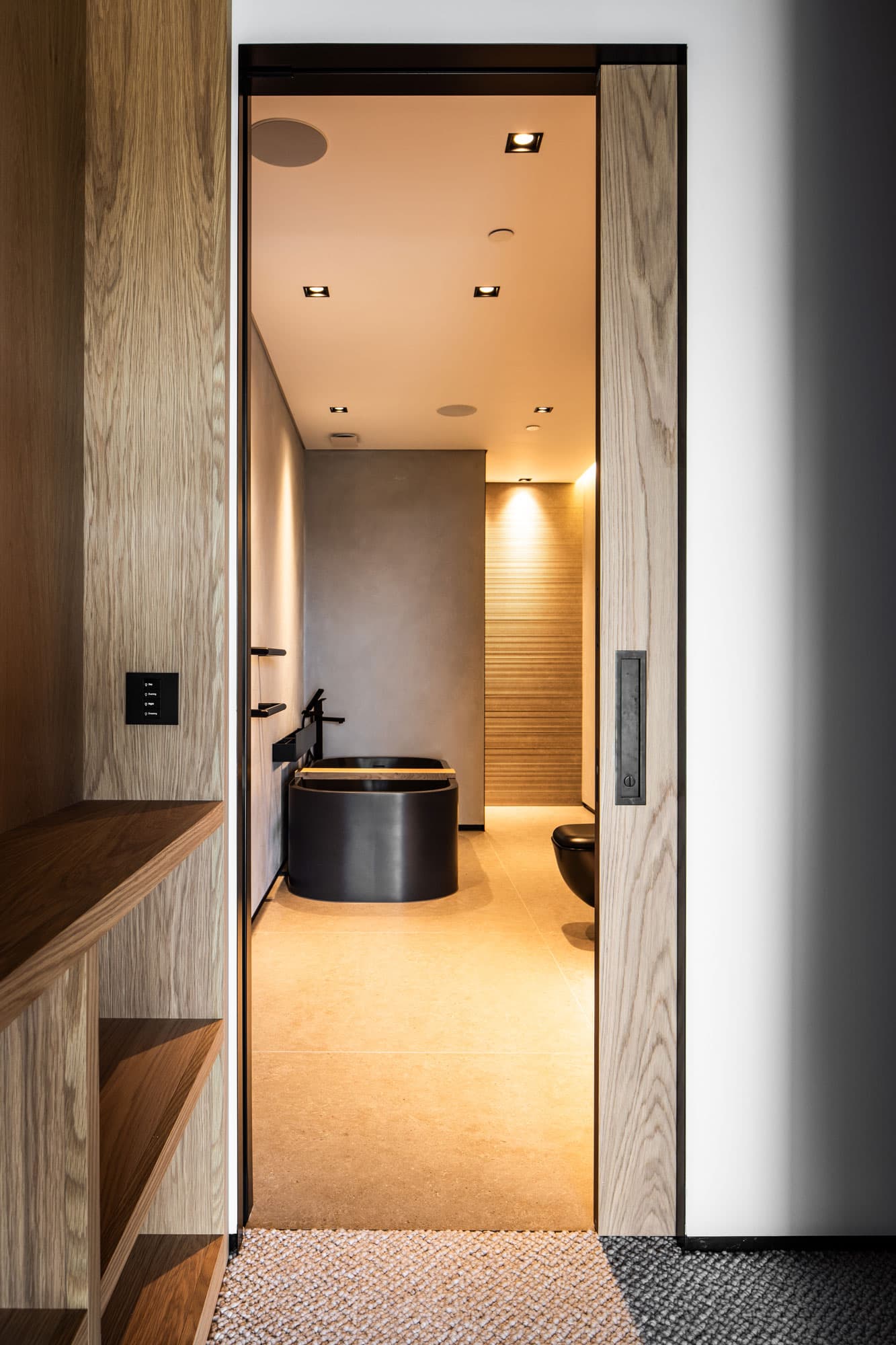 sliding pocket door leading to a luxury bathroom