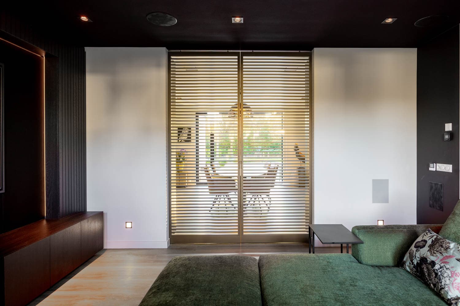 Glenmore steel glazed sliding door dividing a dining room and living room