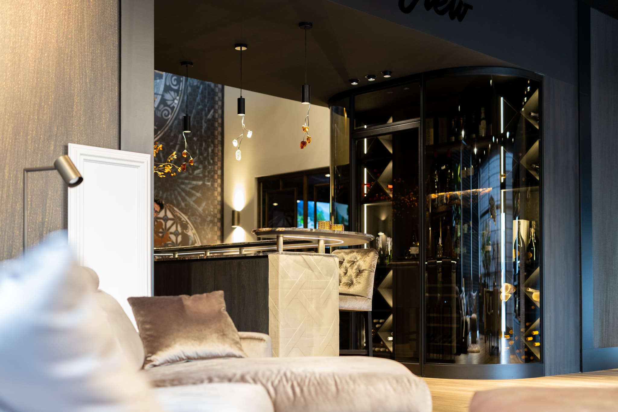 wine cabinet with curved steel glazed doors in a jet black finish