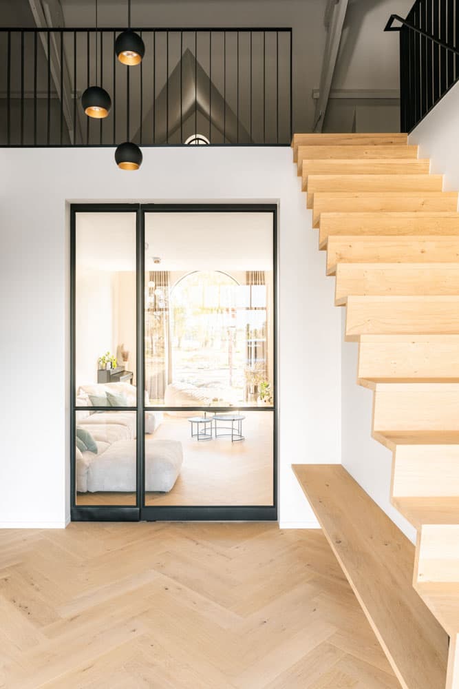 a minimal interior steel door fitted with FritsJurgens pivot hinges